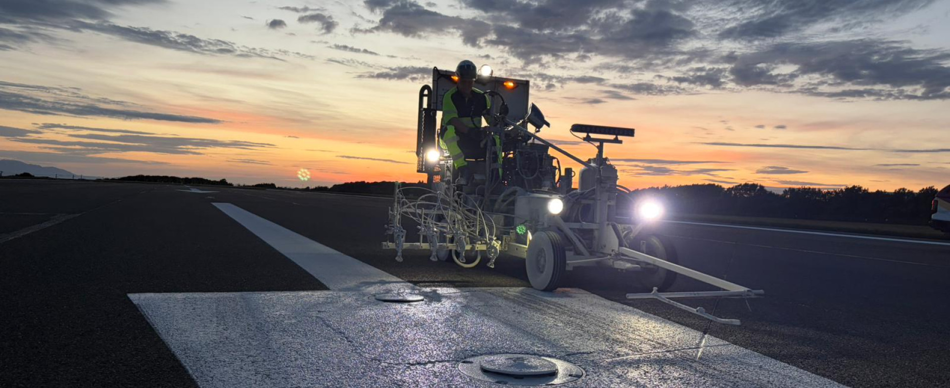 Jointline airfield operatives completing runway marking works at night at Glasgow Prestwick Airport
