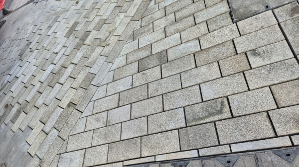Reinstated paving on Cleethorpes promenade, blending with original materials.