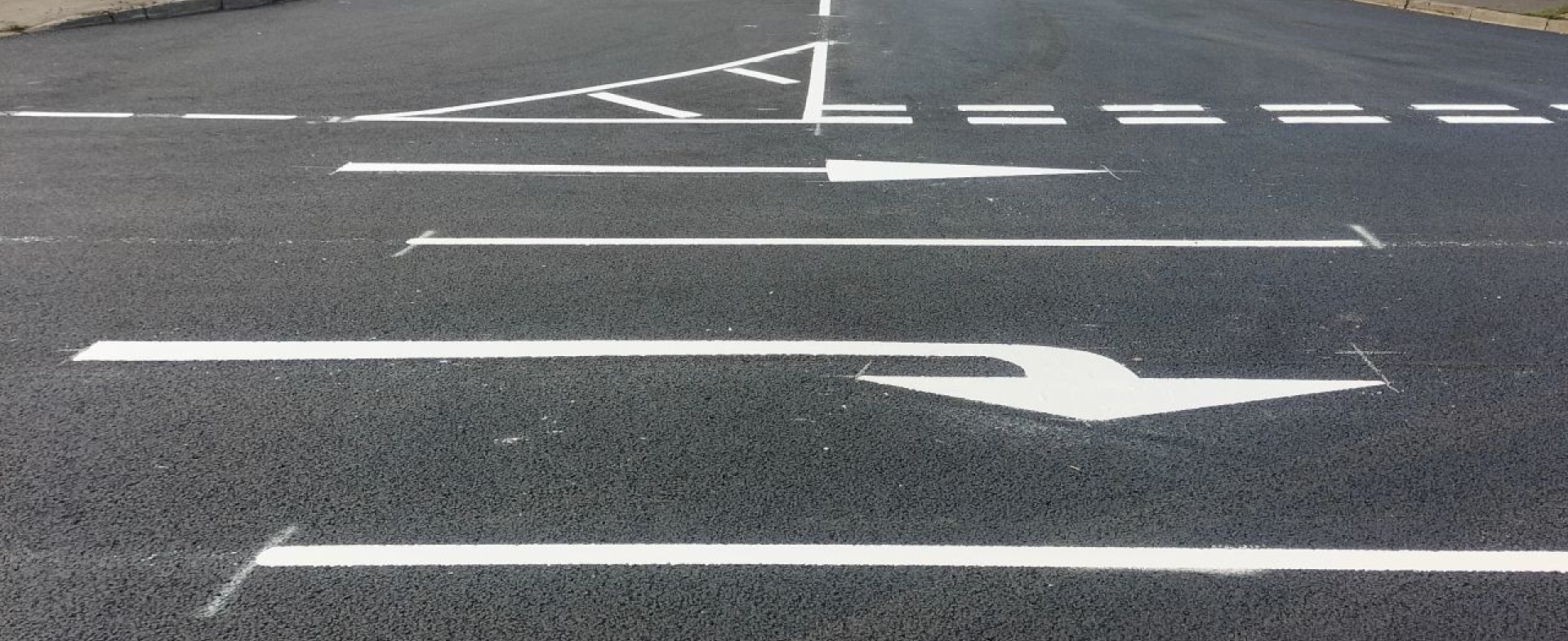 Jointline crew applying high-contrast thermoplastic road markings on a resurfaced surface under full weekend closure conditions.