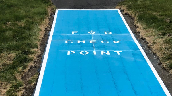 Bright blue FOD box installed on an airfield for improved debris management.