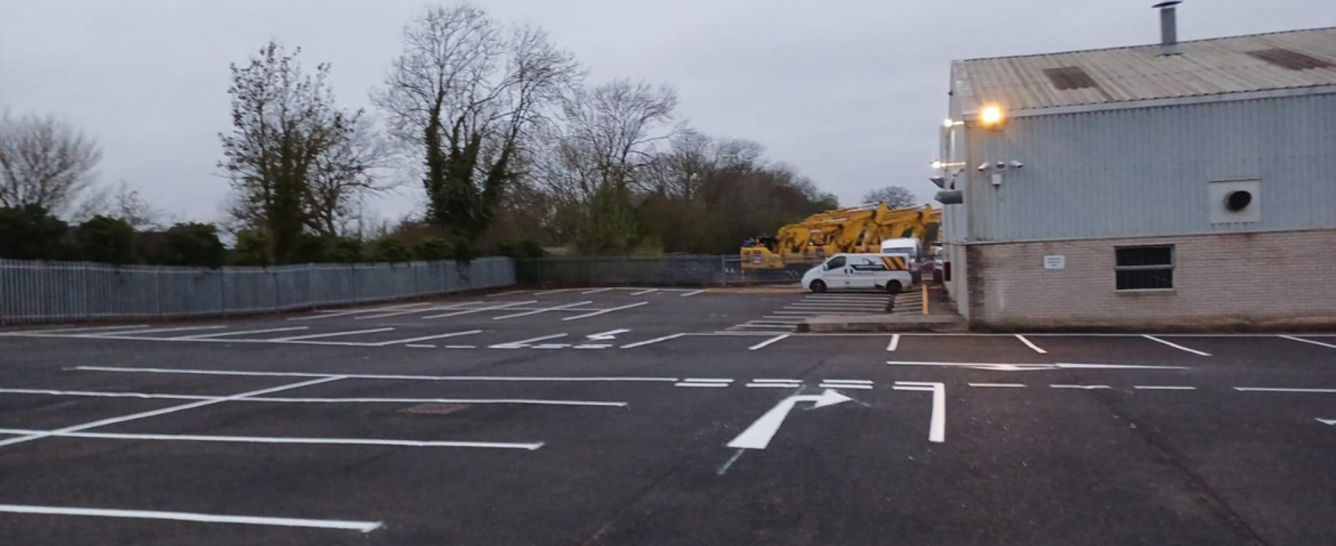 Car park line marking at J N Bentley Shifnal showing over 160 bays, disabled spaces, pedestrian walkways, arrows, and zebra crossings.