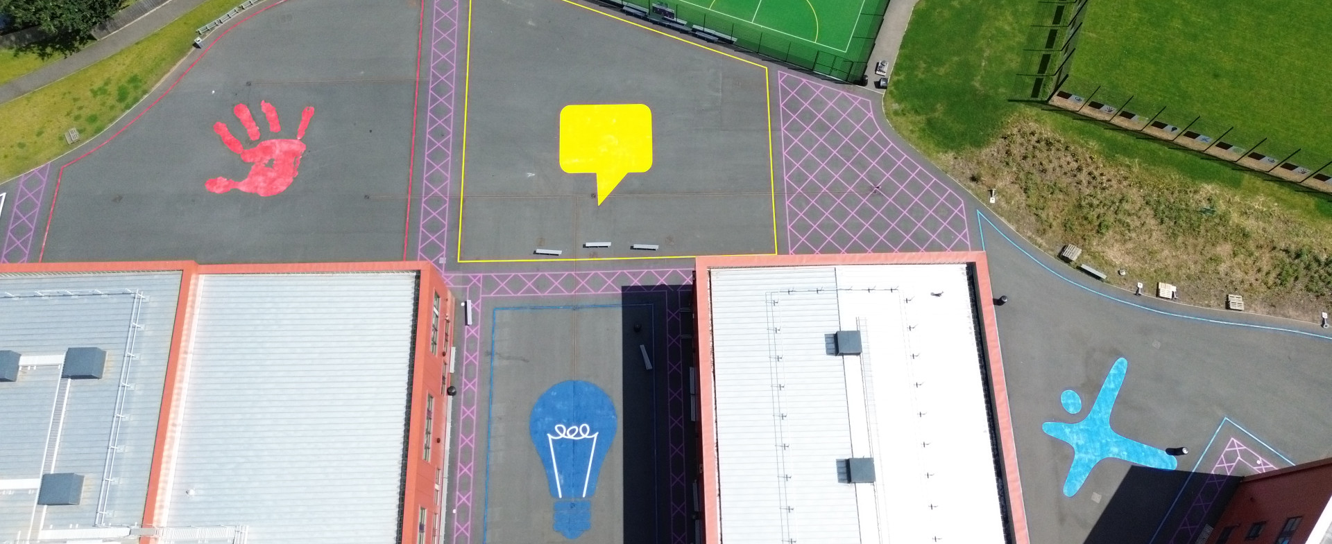 Aerial shot of a playground with colourful emblems painted on its surface