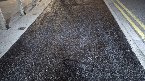 Crew applying Elastomac pothole repair material on a Bradford road.