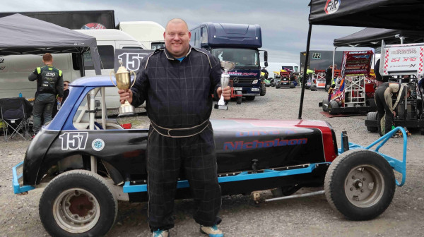 Kevan Woollas celebrating his BriSCA Heritage Formula 2 championship victory.