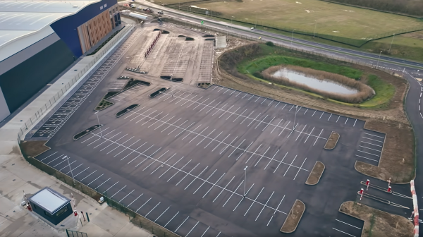 Car park and access road line markings improving traffic flow and safety across a commercial site.